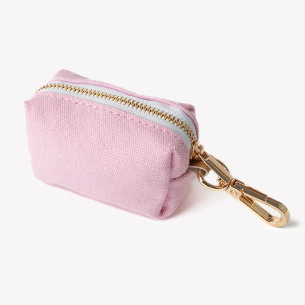 Pink fabric pouch with gold zipper and clasp on a white background