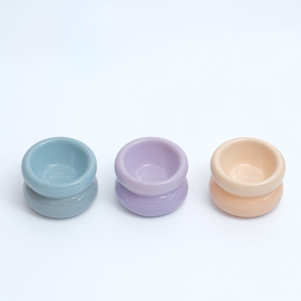 Three small ceramic bowls in pastel colors on a white background