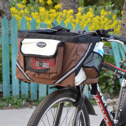 Brown bicycle bag attached to a bike with a blurred background of flowers and a fence.