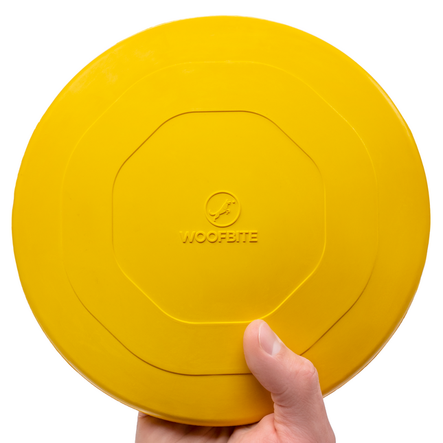Yellow frisbee held by a hand with 'WoofBite' branding on a white background