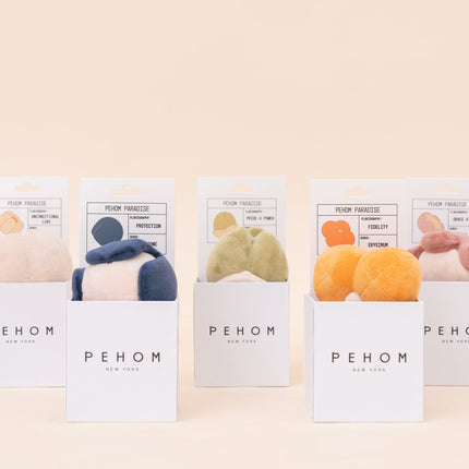 Five packages of PEHOM products on a beige background