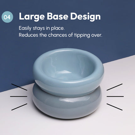 Blue pet bowl with large base design on a white surface and blue background
