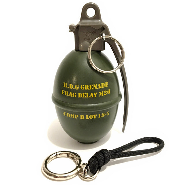 Green grenade-shaped keychain with yellow text on a white background