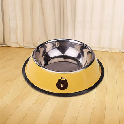 Yellow and black pet bowl on a wooden floor with white curtains in the background
