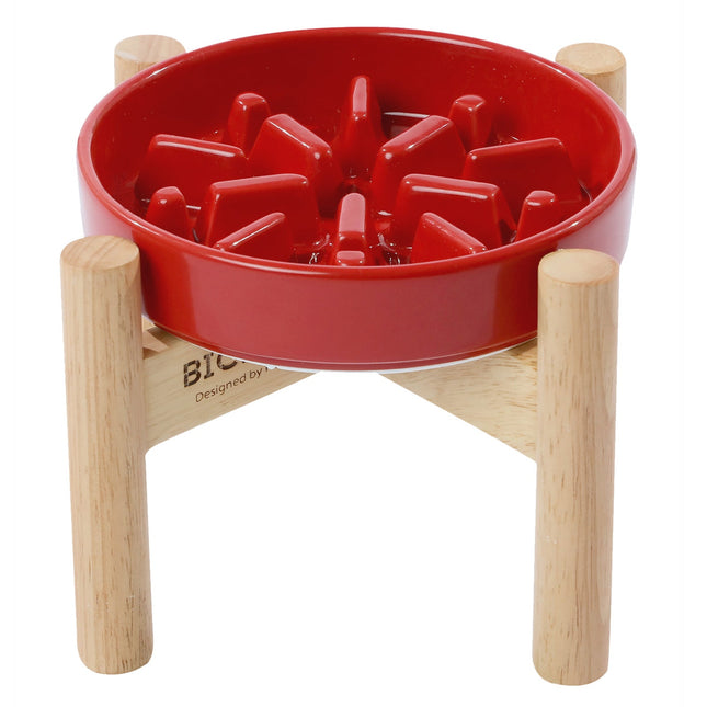 Red dog bowl with wooden stand on a white background