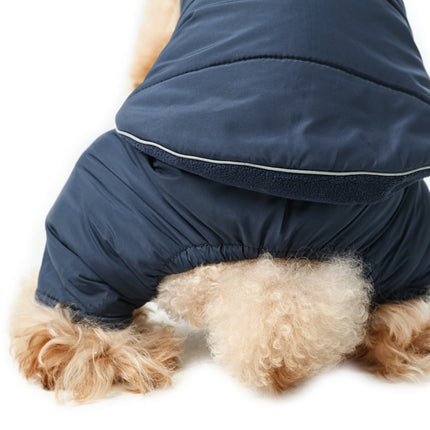 Dog wearing a blue winter coat on a white background
