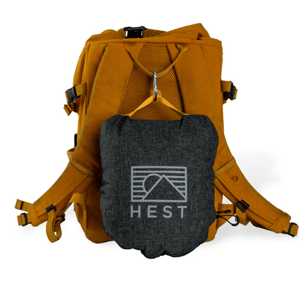 Orange backpack with a gray pouch featuring HEST logo on a white background