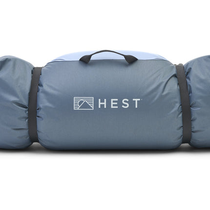 Hest pet bed rolled up with logo on a white background