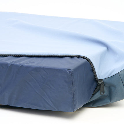 Blue mattress cover on a pet bed with a white background