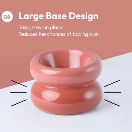 Pink ceramic bowl with large base design on a white and pink background