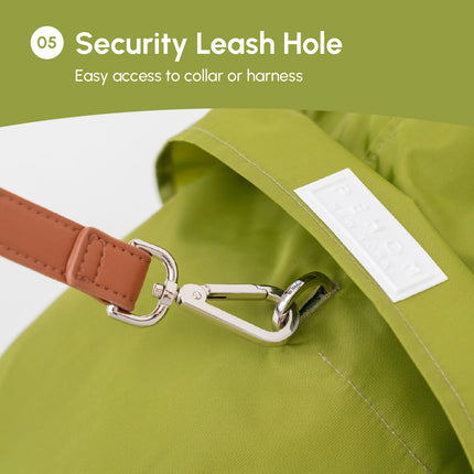 Olive green raincoat with a brown leather leash and silver clasp on a white background