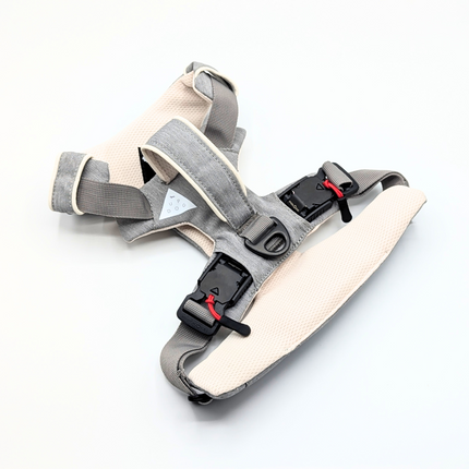 Gray and beige baby carrier with straps on a white background