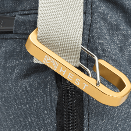 Gold carabiner attached to a blue backpack