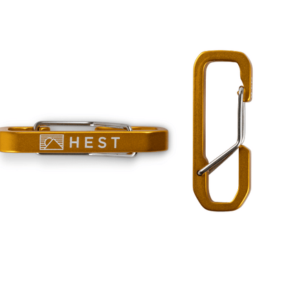 Brown carabiner with 'HEST' logo on a white background