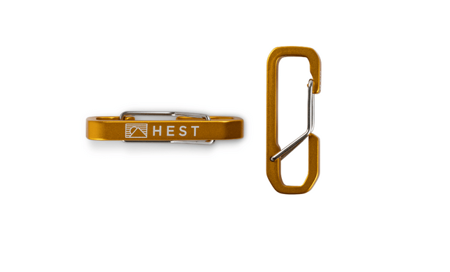 Brown carabiner with 'HEST' logo on a white background