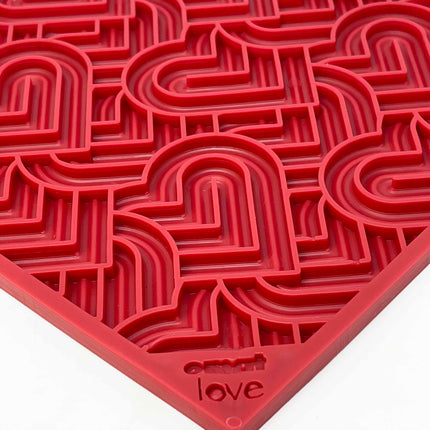 Red textured mat with heart maze-like pattern and 'love' branding on a white background