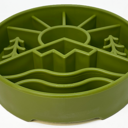 Green silicone feeding bowl with nature-themed design on a white background