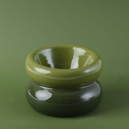 Green ceramic ring-shaped object on a green background