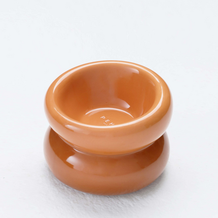 Orange ceramic pet bowl on a white background