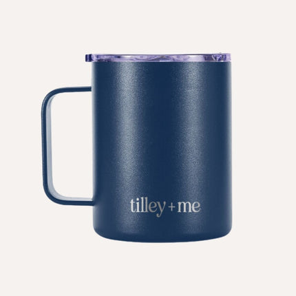 Navy blue mug with 'tilley + me' branding on a white background
