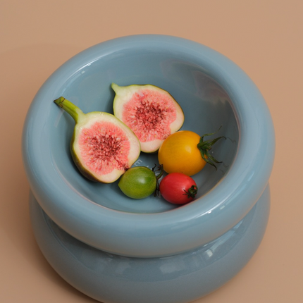 Fruit in a light blue ceramic bowl on a beige background