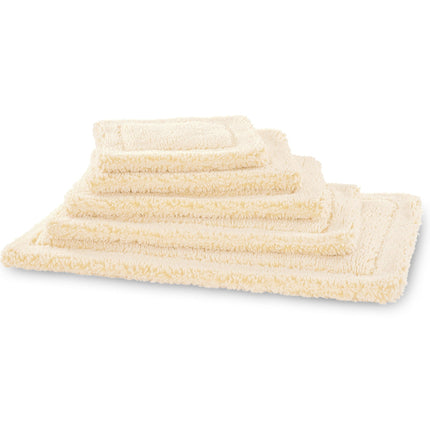 Set of cream-colored pet mats on a white background