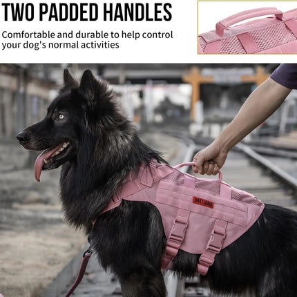 Dog wearing a pink vest with two padded handles, standing on a train platform.