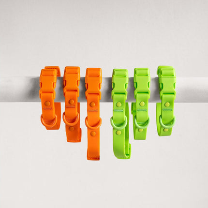 Set of orange and green plastic clips on a white background