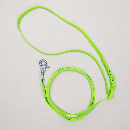 Neon green dog leash with metal clip on a light gray background