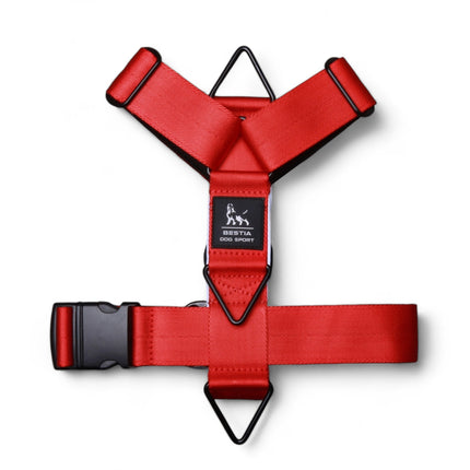 Red dog harness with black straps on a white background
