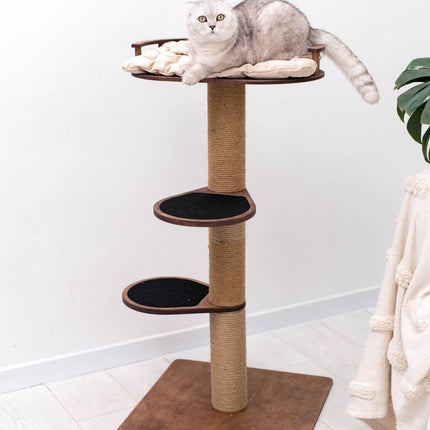 Cat lounging on a multi-level cat tree with a white background