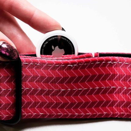 Pink/Red zigzag patterned product with a white circular object on top, held by a hand.