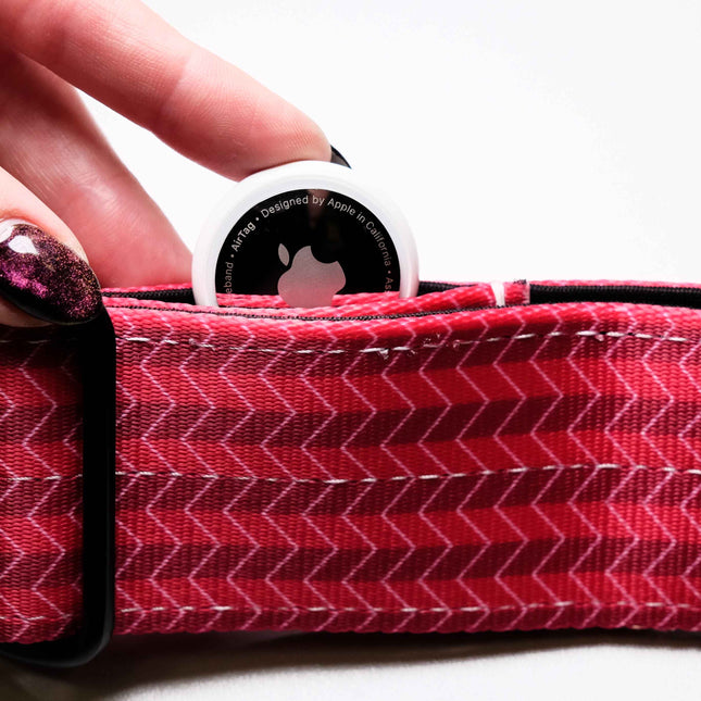Pink/Red zigzag patterned product with a white circular object on top, held by a hand.