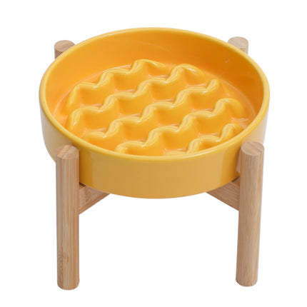 Yellow waffle-patterned bowl on a wooden stand against a white background