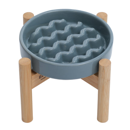 Blue pet feeder with wavy texture on a wooden stand against a white background
