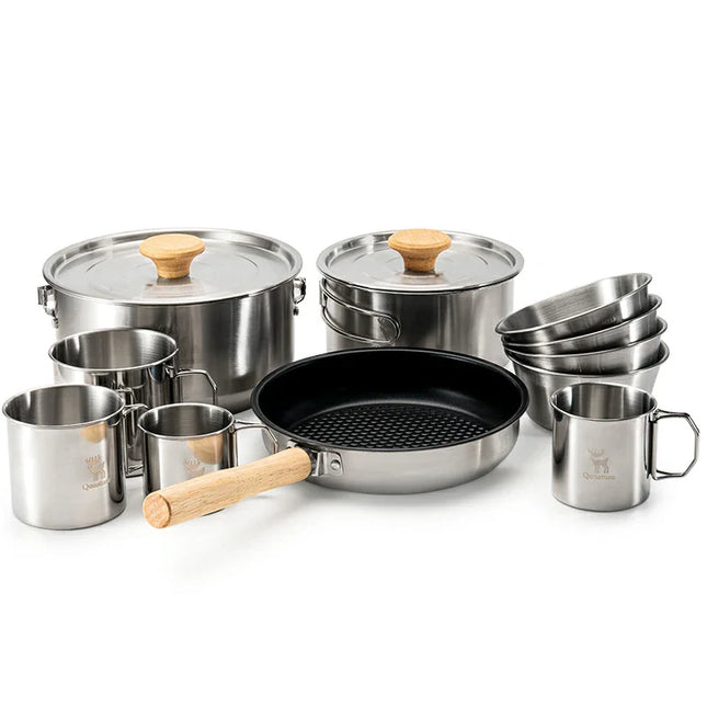 Set of stainless steel cookware with wooden handles on a white background