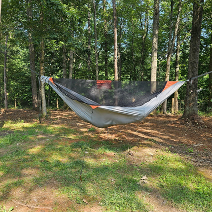 Hammock hanging between trees in a forest setting