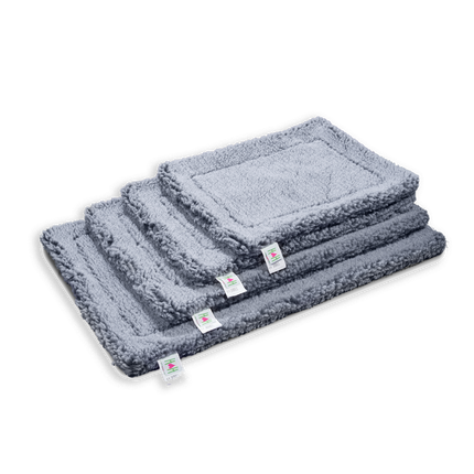 Set of three gray pet mats stacked on a white background
