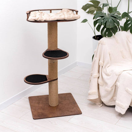 Cat tree with multiple levels on a white floor next to a plant and a white chair.